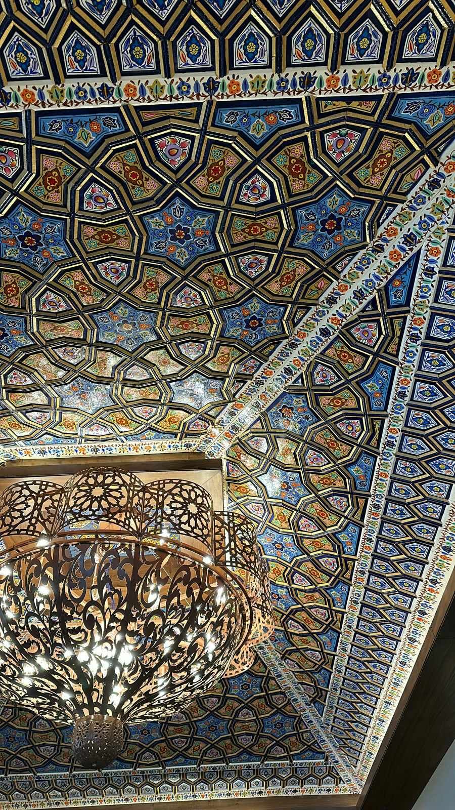 A Kashmiri khatamband ceiling in Srinagar, interlocked wooden stars and hexagons hand-painted in lapis, gold and vermilion paper machie naqashi.