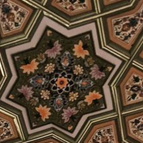 Chinar leaves in autumn orange radiating around a star panel of a hand-painted khatamband ceiling — the bouni motif.