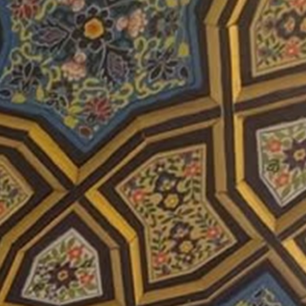Khatamband ceiling cells painted edge to edge in the hazara thousand-flower motif, with almost no ground left showing between the blooms.