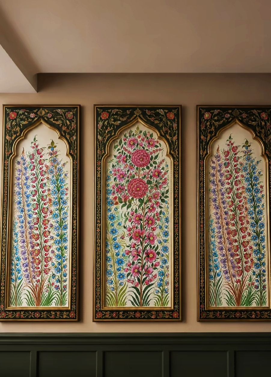 Three arched paper machie wall panels on an ivory ground painted with rising gardens of roses and iris in gold frames.