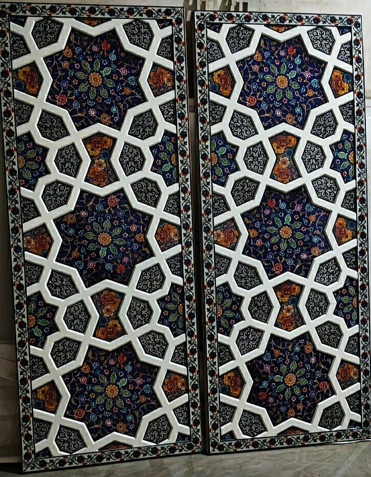Pair of khatamband wall panels with white star interlace over a lapis ground filled with painted paper machie flowers.