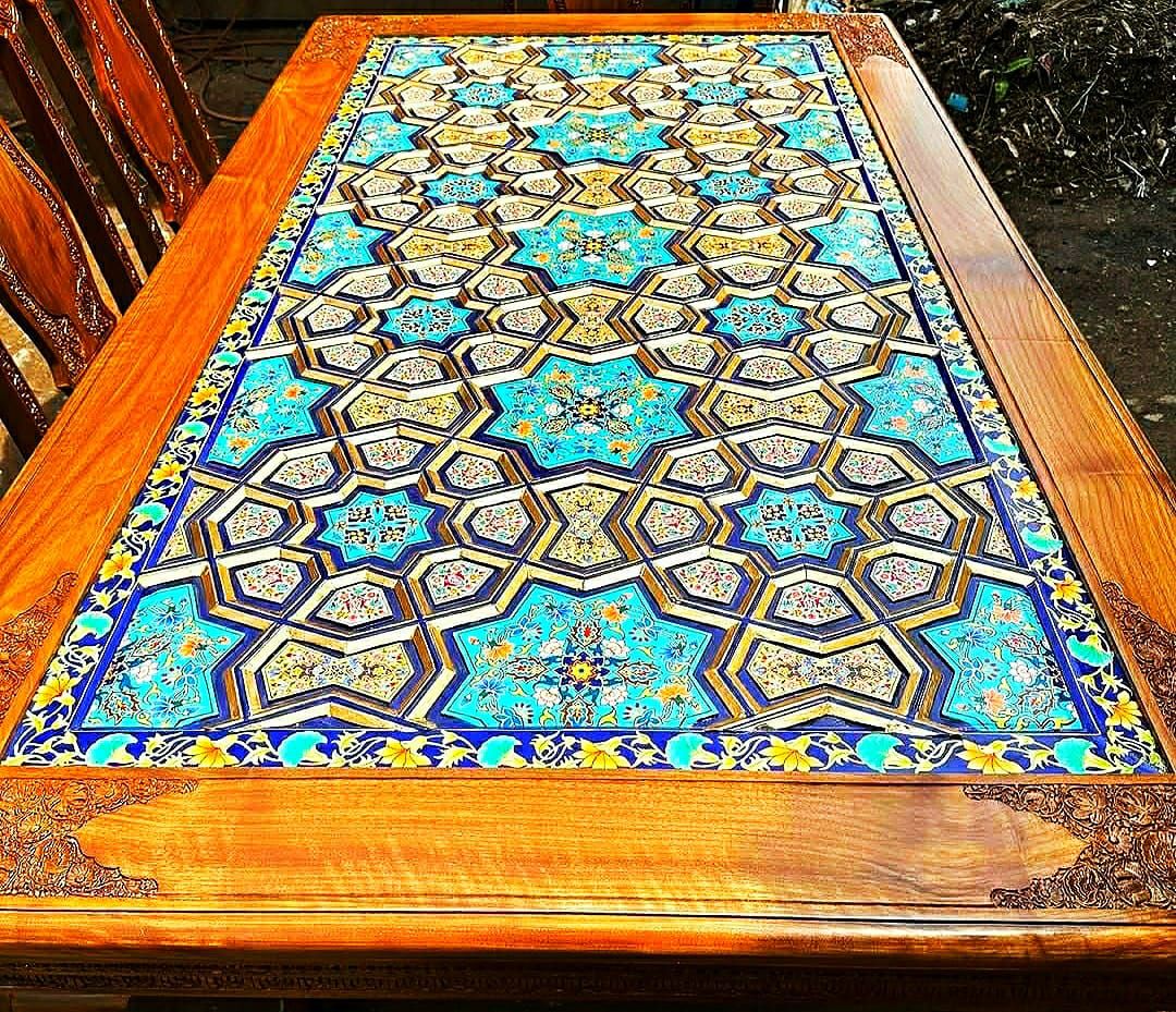 Carved walnut dining table with a khatamband and paper machie top in turquoise and gold star interlace under heavy lacquer.